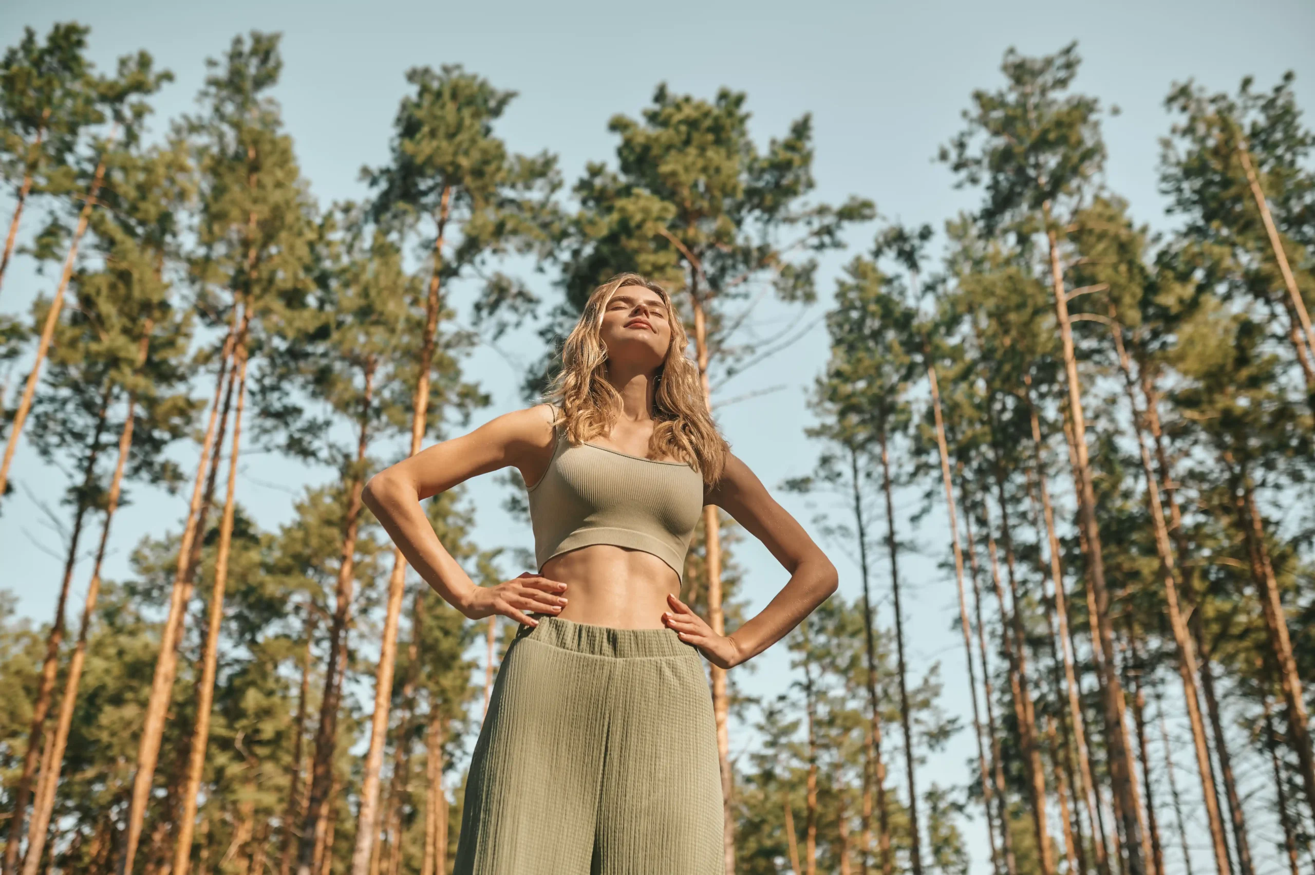 woman-practising-yoga-park-looking-involved